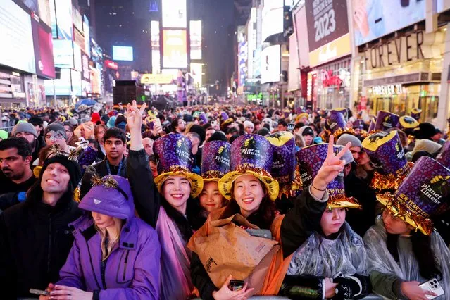 People gather in Times Square for New Year celebrations during the first New Year's Eve event without restrictions since the coronavirus disease (COVID-19) pandemic in the Manhattan borough of New York City, New York, U.S., December 31, 2022. (Photo by Andrew Kelly/Reuters)