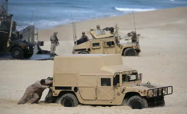 NATO soldiers attend a NATO military exercise at Raposa beach, near Setubal, Portugal October 20, 2015. NATO and its allies opened their largest military exercise in more than a decade on Monday, choosing the central Mediterranean to showcase strengths that face threats from Russia's growing military presence from the Baltics to Syria. (Photo by Rafael Marchante/Reuters)