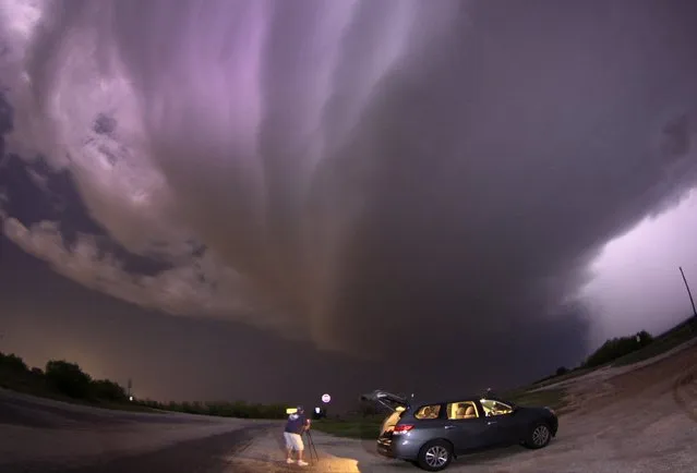A large TVS (tornadic vortex signature) thunderstorm supercell passes over storm chaser Brad Mack in Graham, Texas late in this April 23, 2014 file picture. I was covering the Tornado and Dixie Alleys, areas of the central and southern United States which are vulnerable to strong tornados, due to the severe weather forecast for that week. (Photo and caption by Gene Blevins/Reuters)