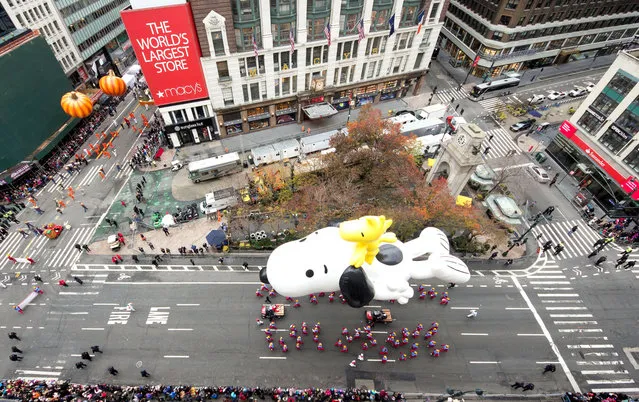 A Snoopy balloon floats for the the 88th Annual Macy's Thanksgiving Day Parade outside Macy's Department Store in Herald Square on November 27, 2014 in New York City. (Photo by Ben Hider/Getty Images)