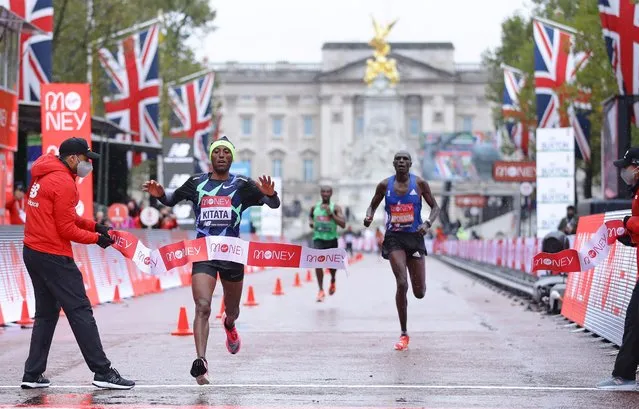 Ethiopia's Shura Kitata (2nd L) breaks the tape as he wins the elite men's race of the 2020 London Marathon in central London on October 4, 2020. This year's London marathon, an elite-athlete only event, takes place in a “secure biosphere” on a enclosed, looped course, in St James's Park, due to coronavirus restrictions. (Photo by Richard Heathcote/Pool via AFP Photo)