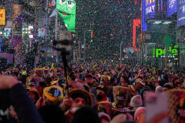 Revelers celebrate the mark of the new year on January 1, 2022 in New York City. People began celebrating New Year's Eve at Times Square in 1904, in 1907 the New Year's Eve Ball made its first descent from the flagpole at One Times Square. (Photo by David Dee Delgado/Getty Images)