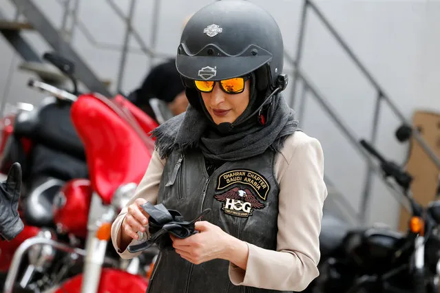 Maryam Ahmed Al-Moalem puts on her gloves during her lessons in advanced motorbike training at Harley Davidson training centre in Manama, Bahrain, March 16, 2018. The recent decisions have opened up several new avenues for Saudi women, who can now attend soccer matches, take part in sport and venture into new fields including cinema, photography and arts. (Photo by Hamad I. Mohammed/Reuters)