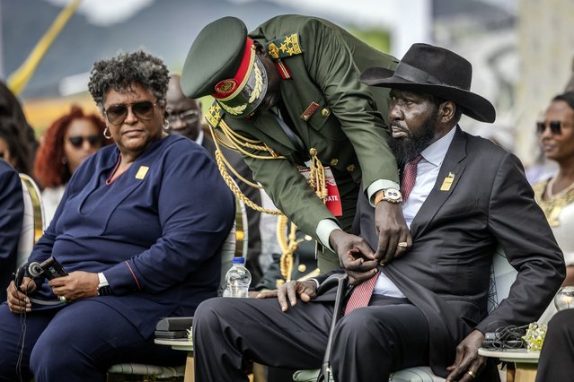 South Sudan's President Salva Kiir (R) is assisted by a member of the South Sudan People's Defence Forces (SSPDF) to unbutton his blazer during the official inauguration ceremony of the Grand Ethiopian Renaissance Dam (GERD) in Guba, on September 9, 2025. Ethiopia inaugurated the continent's largest hydroelectric project on September 9, 2025 with Prime Minister Abiy Ahmed calling it a “great achievement for all black people” despite years of diplomatic rancour over the dam with downstream neighbour Egypt. (Photo by Luis Tato/AFP Photo)