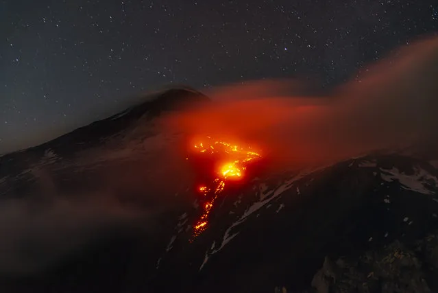 A photo shows an eruption at Volcano Etna in Catania, Italy on December 22, 2022. The eruption began with a timid awakening on November 27, 2022 interrupted the volcano's rest which lasted over 5 months. The effusive vent located at about 2800 meters on the eastern flank of the southeast crater feeds a lava flow that heads towards the desert valley below. Photo taken on Volcano Etna at 2500 metres amsl, near Catania. (Photo by Salvatore Allegra/Anadolu Agency via Getty Images)