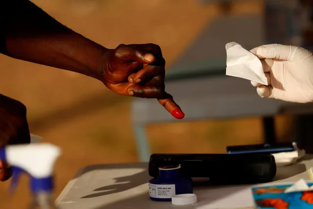 A person has a finger inked at a polling station during Ghana's presidential and parliamentary elections in Kyebi, Ghana on December 7, 2020. (Photo by Francis Kokoroko/Reuters)