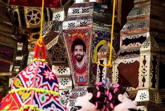 A picture taken on April 30, 2018 shows a Ramadan lantern bearing the image of Liverpool' s Egyptian midfielder Mohamed Salah hanging on sale at a market in the capital Cairo's central Sayyida Zeinab district. Patriotic statements, flashy commercials, and an anti- drug campaign: Mohamed Salah's dazzling displays for Liverpool have taken the football world by storm, and on his home turf in Egypt seemingly everyone wants a piece of him. (Photo by Khaled Desouki/AFP Photo)
