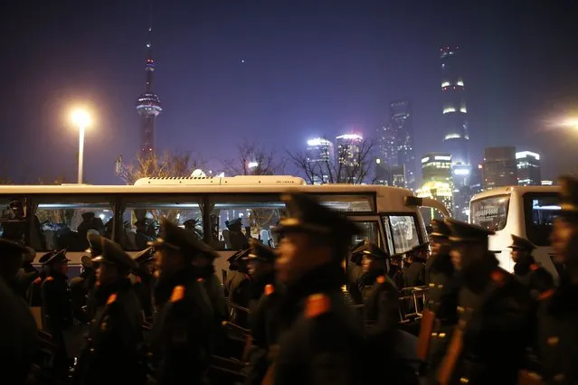 Paramilitary police officers walk on the location where people were killed in a stampede incident during a New Year's celebration on the Bund in Shanghai January 1, 2015. (Photo by Aly Song/Reuters)