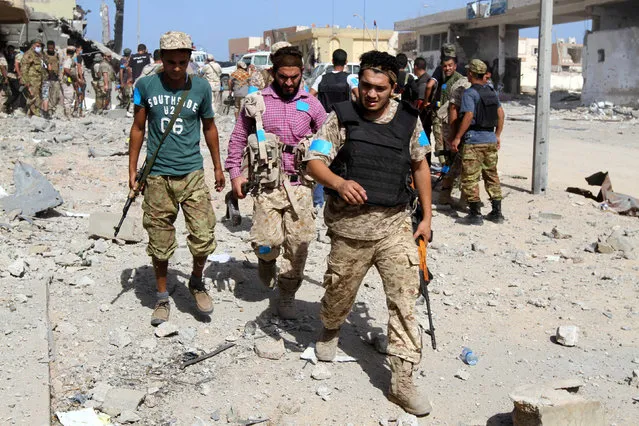Fighters of Libyan forces allied with the U.N.-backed government walk during a battle with Islamic State militants in Giza Bahreya, in Sirte, Libya October 27, 2016. (Photo by Hani Amara/Reuters)