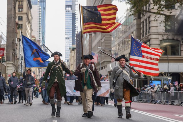 People in colonial clothing march in the Veterans Day parade on Fifth Avenue in Manhattan, New York City on November 11, 2025. (Photo by Kylie Cooper/Reuters)