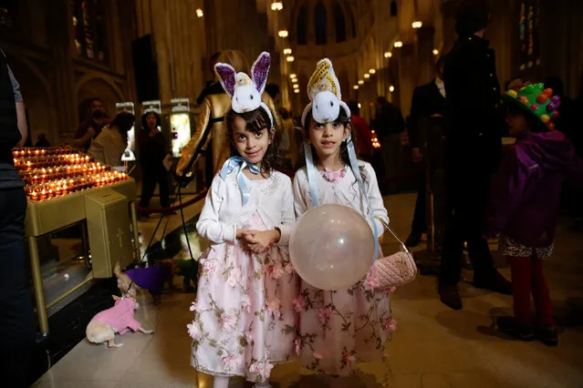 Eleanor and Margaret Santana pose for a photograph in St. Patrick's Cathedral, during the annual Easter Parade and Bonnet Festival in the Manhattan borough of New York City, New York, U.S., April 1, 2018. (Photo by Gaia Squarci/Reuters)