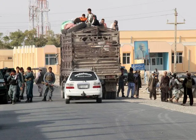 Afghan residents sit on a truck as they leave their home after a battle with the Taliban in Kunduz Province, Afghanistan September 28, 2015. Taliban fighters battled their way into the centre of Kunduz city in Afghanistan's north on Monday and were within blocks of the governor's compound, the worst breach of a major city in nearly 14 years of war, witnesses and security sources said. (Photo by Reuters/Stringer)