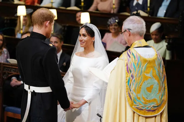 The Prince of Wales leads Meghan Markle up the aisle of St George' s Chapel, Windsor Castle for her wedding to Prince Harry Saturday, May 19, 2018. (Photo by Dominic Lipinski/ PA Wire)