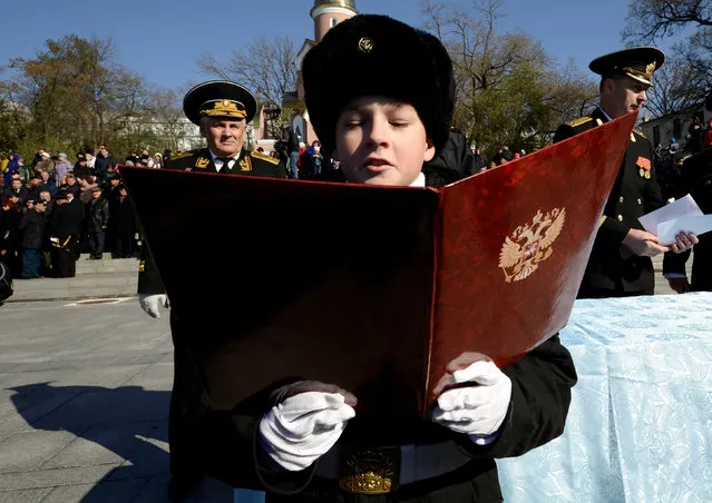 A young naval cadet takes oath at the Vladivostok Presidential Cadet School in Vladivostok, Russia, October 29, 2016. (Photo by Yuri Maltsev/Reuters)