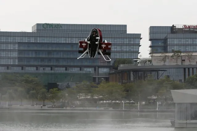 Michael Read, Director of Flight Operations from New Zealand-based Martin Aircraft Company, flies on a Martin Jetpack during a demonstration over a water park in Shenzhen, China December 6, 2015. KuangChi Science Ltd, a Hong Kong-listed Chinese company and investor of Martin Aircraft, will sell the flying machine in mainland China for 1.6 million yuan ($249,902), according to the company.   REUTERS/Bobby Yip