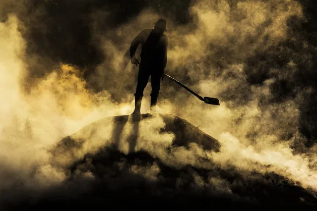 “Out from Hell”. 6:00 am, near Biertan village, in Transylvania, worker preparing charcoal. Location: Romania. (Photo and caption by Razvan Teodoreanu/National Geographic Traveler Photo Contest)