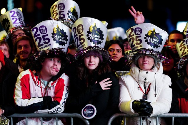 People arrive to Times Square ahead of celebrations of the New Year's Eve, in New York City, New York, U.S., December 31, 2024. (Photo by Eduardo Munoz/Reuters)