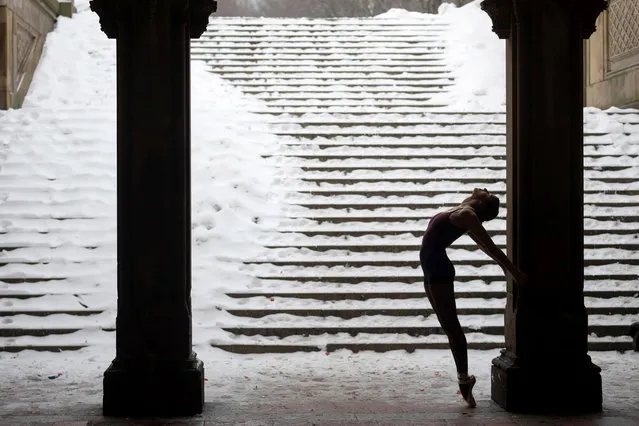 A ballerina standing on pointe poses under the Bethesda Terrace during a snow storm in Central Park on February 18, 2021 in New York City. The U.S. National Weather Service issued a winter weather advisory that a total of 6 to 8 inches of snow is expected on Thursday and Friday in parts of the Northeast, including Southeast New York. (Photo by Alexi Rosenfeld/Getty Images)