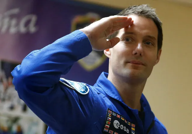 Crew member of the International Space Station (ISS) expedition 50/51 Thomas Pesquet of France salutes while standing behind a glass wall during a news conference before a launch to the ISS scheduled on November 17, at the Baikonur cosmodrome in Kazakhstan, November 16, 2016. (Photo by Shamil Zhumatov/Reuters)