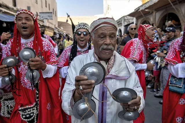 Members of traditional Gnawa bands and dancers take part in a parade on the streets during the opening ceremony of the 24th edition of the Gnaoua World Music Festival in Essaouira, Morocco on June 22, 2023. The event runs from 22 to 24 June. (Photo by Jalal Morchidi/EPA/EFE)