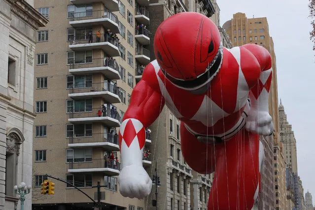 The Red Ranger balloon flies over Central Park West avenue during the 90th annual Macy's Thanksgiving Day Parade on November 24, 2016 in New York. (Photo by Kena Betancur/AFP Photo)