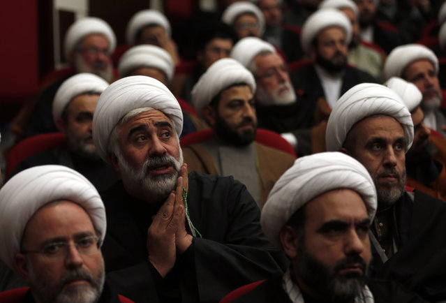 Lebanese Shiite clerics listen to their leader, Sheik Hassan Nasrallah, as he speaks via a video link during a memorial service for Sheikh Mohammad Khatoun, who died last week of cancer, in the southern suburb of Beirut, Lebanon, Sunday, January 3, 2016. Nasrallah strongly condemned Saudi Arabia for executing prominent Saudi opposition Shiite cleric Nimr al-Nimr at the event. Khatoun was a member of Hezbollah Central Council. (Photo by Hassan Ammar/AP Photo)