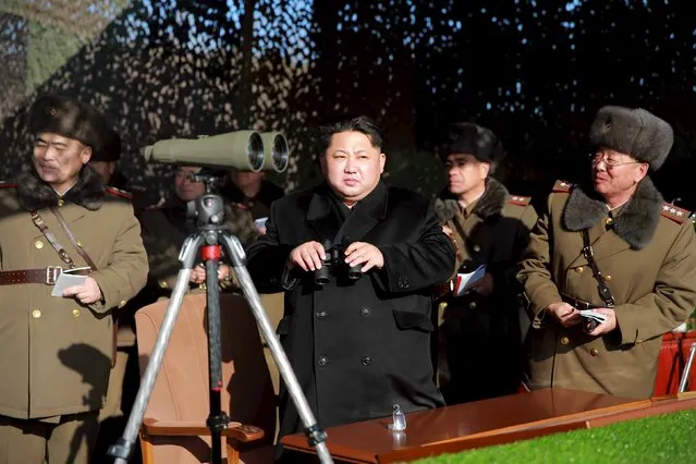 North Korean leader Kim Jong Un (C) watches a firing contest of the KPA artillery units at undisclosed location in this photo released by North Korea's Korean Central News Agency (KCNA) in Pyongyang on January 5, 2016. (Photo by Reuters/KCNA)