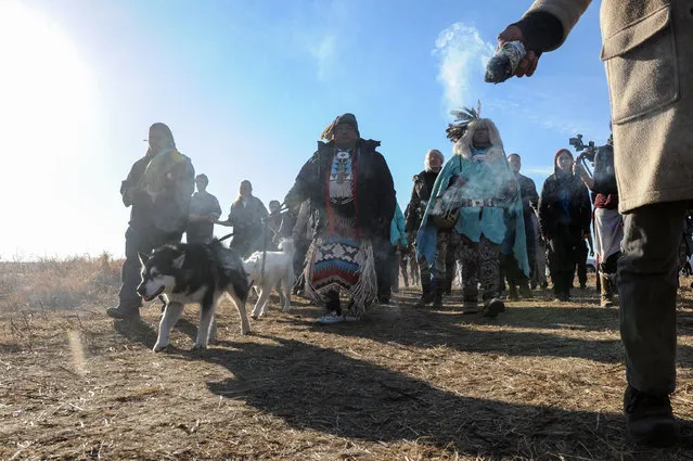 People participate in a prayer march near Turtle Island during a protest against plans to pass the Dakota Access pipeline near the Standing Rock Indian Reservation, near Cannon Ball, North Dakota, U.S. November 26, 2016. (Photo by Stephanie Keith/Reuters)