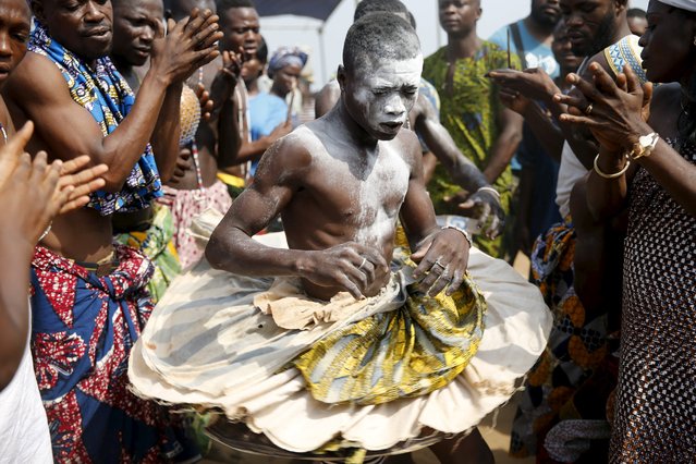A devotee is cheered as he dances at the annual voodoo festival in Ouidah January 10, 2016. (Photo by Akintunde Akinleye/Reuters)