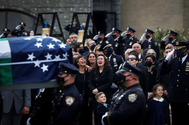 The family of New York Police Department (NYPD) officer Anastasios Tsakos, who was killed in the line of duty on April 27, 2021, by an impaired driver while responding to a highway crash, reacts as his casket is carried from his funeral service in Greenlawn, New York, U.S., May 4, 2021. (Photo by Shannon Stapleton/Reuters)