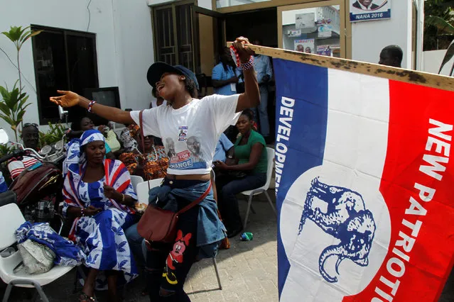 A supporter of Ghana's presidential candidate Nana Akufo-Addo of the opposition New Patriotic Party (NPP) holds a party flag as she reacts at party's headquaters in Accra, Ghana December 8, 2016. (Photo by Luc Gnago/Reuters)