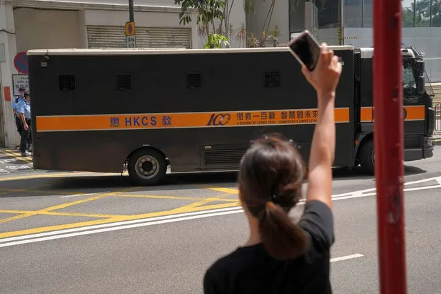 A woman gestures to a correctional services department van, after activist Joshua Wong was sentenced for participating in an unauthorised assembly on June 4, 2020, outside the court in Hong Kong, China on May 6, 2021. (Photo by Lam Yik/Reuters)