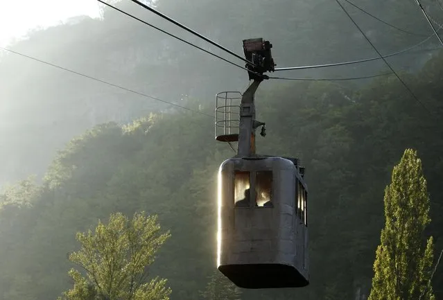 A 60-year-old cable car passes above the town of Chiatura, some 220 km (136 miles) northwest of Tbilisi, September 12, 2013. (Photo by David Mdzinarishvili/Reuters)