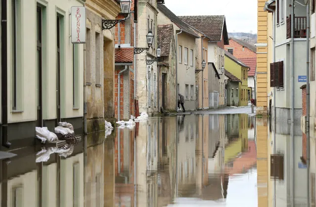 Man is seen in flooded street in Hrvatska Kostajnica, Croatia March 14, 2018. (Photo by Antonio Bronic/Reuters)