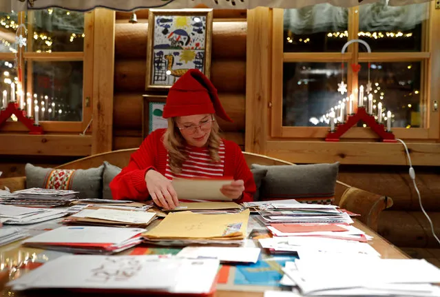 Elina, dressed as a Christmas elf, reads letters from around the world which were sent to Santa Claus at the Santa Claus' Post Office, in the Arctic Circle near Rovaniemi, Finland December 15, 2016. (Photo by Pawel Kopczynski/Reuters)