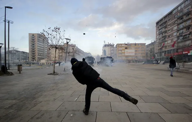 KOSOVO: A protester throws a rock at police during clashes in Pristina, Kosovo January 9, 2016. (Photo by Agron Beqiri/Reuters)