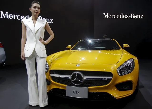 A model poses beside a Mercedes-Benz GTS during a media presentation of the 36th Bangkok International Motor Show in Bangkok March 24, 2015. (Photo by Chaiwat Subprasom/Reuters)