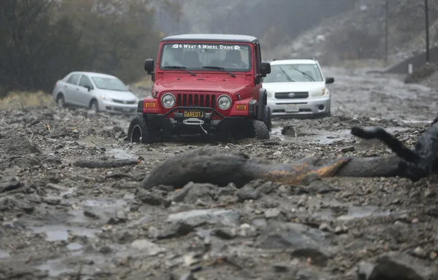 A mudslide trapped several vehicles along Valley of the Falls Drive in Forest Falls in San Bernardino County, Calif., on Thursday, November 29, 2018. Forecasters say the weather system that has been raining all day on Southern California has developed instability and may produce thunderstorms. Mud and rock slides have also closed two mountain highways northeast of Los Angeles. (Photo by Stan Lim/The Orange County Register via AP Photo)
