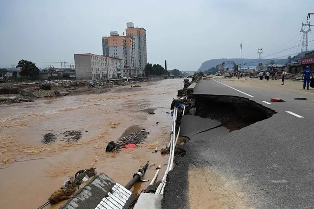 Road collapses after severe flooding and landslides in recent days have hit the county-level Gongyi city, near Zhengzhou, in central Chinas Henan province on July 22, 2021. (Photo by Jade Gao/AFP Photo)