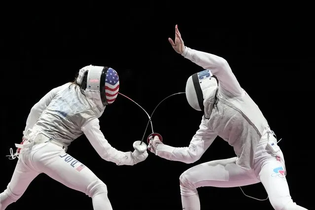 Inna Deriglazova of the Russian Olympic Committee, right, and Lee Kiefer of the United States compete in the women's individual Foil final competition at the 2020 Summer Olympics, Sunday, July 25, 2021, in Chiba, Japan. (Photo by Hassan Ammar/AP Photo)