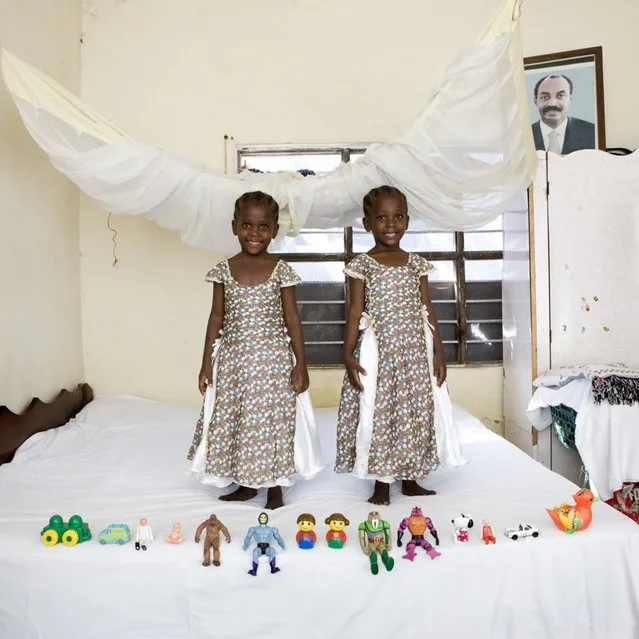 Arafa & Aisha – Bububu, Zanzibar. Arafa and Aisha are twins. They sleep in the same bed, have the same clothes, go to school together and share the same toys. They live in a two-room house in which both of the rooms are bedrooms, and the kitchen and restroom are outside. The big photo above the closet is a portrait of the formal president of Zanzibar. “Toy Stories” project. (Gabriele Galimberti)