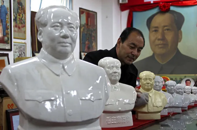 Dang Guihong, a judicial official, wipes statues of China's late Chairman Mao Zedong at an exhibition room in Yuncheng, Shanxi province, December 10, 2013. Dang is going to exhibit around 5000 pieces of his revolution collection, including badges, statues and portraits ahead of the 120th anniversary of Mao's birth. (Photo by Reuters/Stringer)