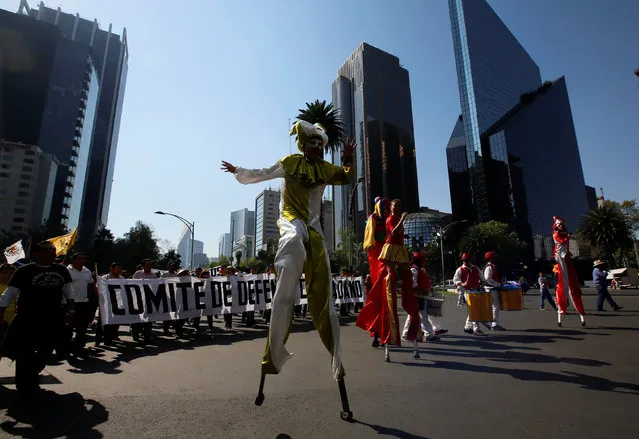Artists perform along the street during a protest against a fuel price hike in Mexico City, Mexico January 22, 2017. (Photo by Henry Romero/Reuters)