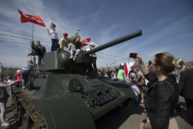 Children play on a Soviet era tank in Gorky Park in Moscow, Russia, on Saturday, May, 9, 2015, during the commemorations of the 70th anniversary of victory over Nazi Germany. (Photo by Alexander Zemlianichenko Jr./AP Photo)