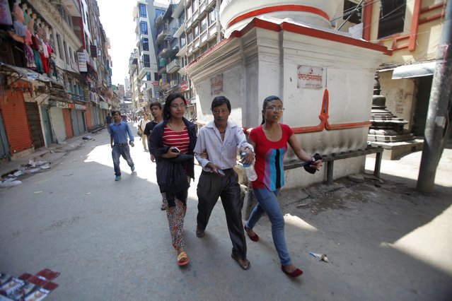 Nepalese people rush to safety after an earthquake hit Nepal in Kathmandu, Nepal, Tuesday, May 12, 2015. (Photo by Bikram Rai/AP Photo)