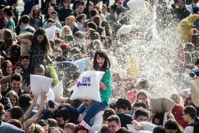 People participate in a pillow fight to mark International Pillow Fight Day in the Heroes' Square, in central Budapest, Hungary, Saturday, April  2, 2016. (Photo by Zoltan Balogh/MTI via AP Photo)