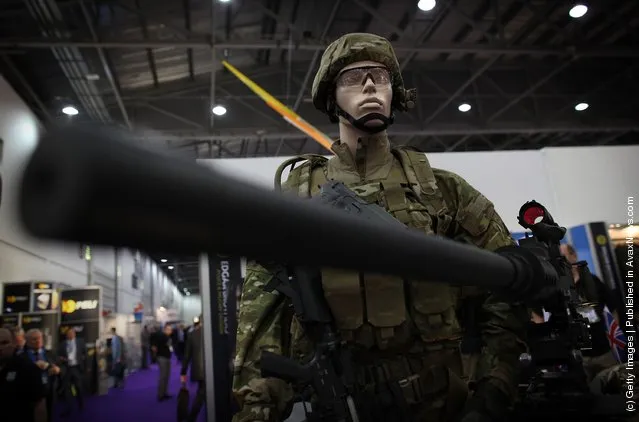 Uniforms and weapons are displayed at the Defence and Security Exhibition