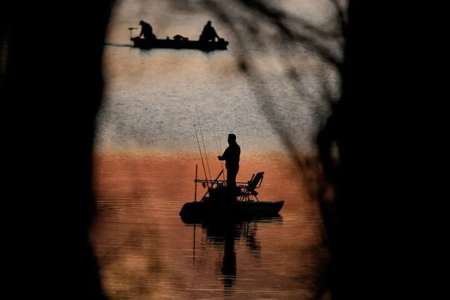 People fish at dusk on a unseasonably warm day, Wednesday, March 6, 2024, in Shawnee, Kan. (Photo by Charlie Riedel/AP Photo)