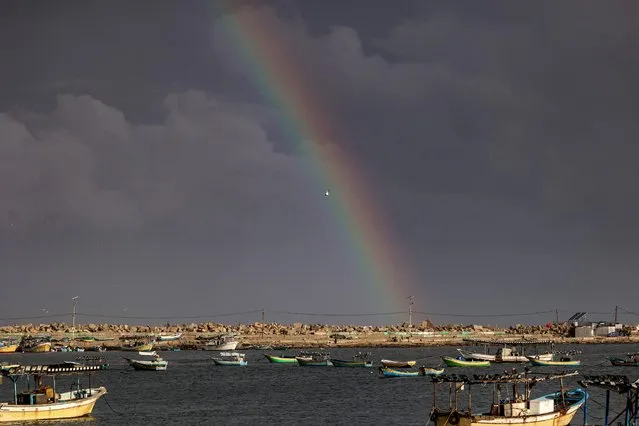 A rainbow appears in the sky above the Gaza port on rainy weather, in Gaza City on November 20, 2021. (Photo by Mohammed Abed/AFP Photo)