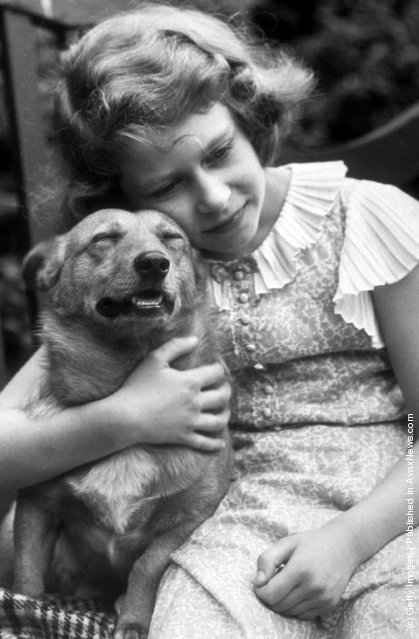 1936: Princess Elizabeth hugging a corgi dog